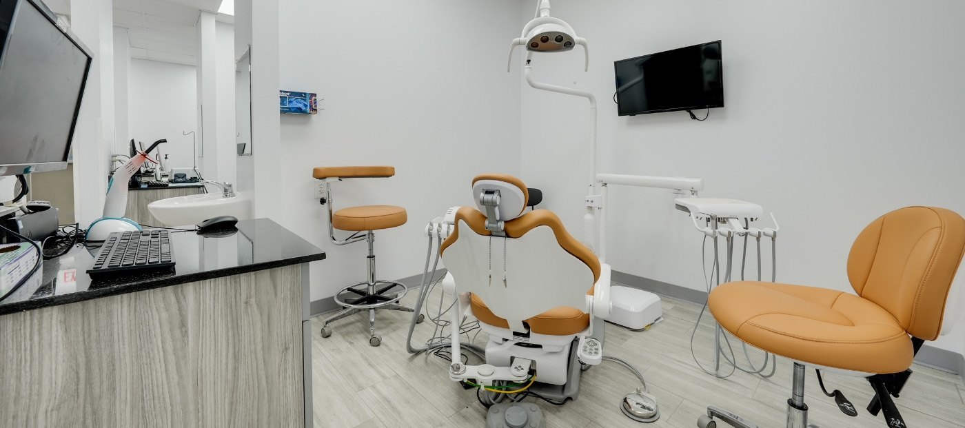 Woman in orange blouse smiling with dental implants in Arlington