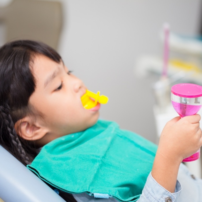 Child getting silver diamine fluoride treatment from children's dentist in Arlington