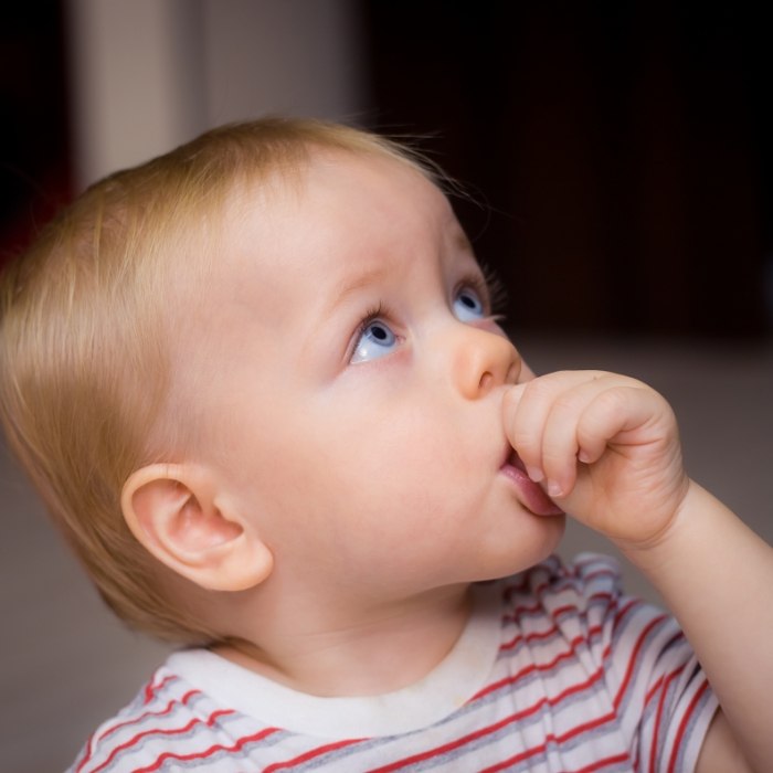 Infant sucking their thumb