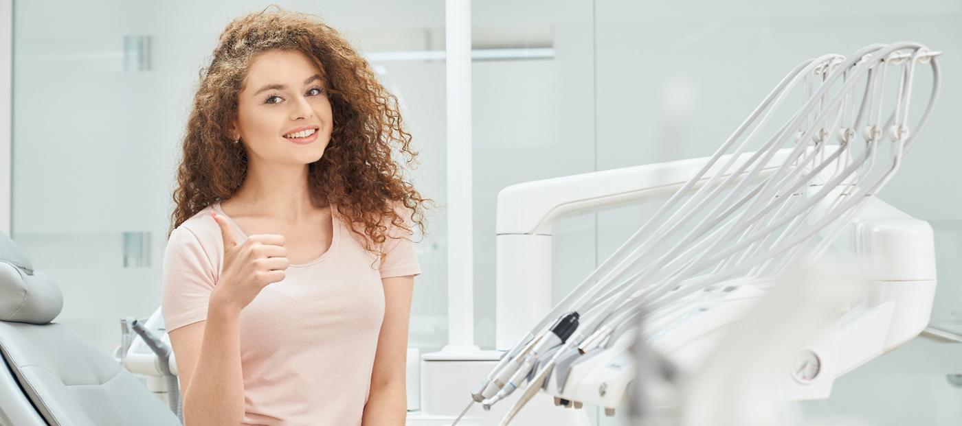 Female patient in pink shirt giving thumbs up