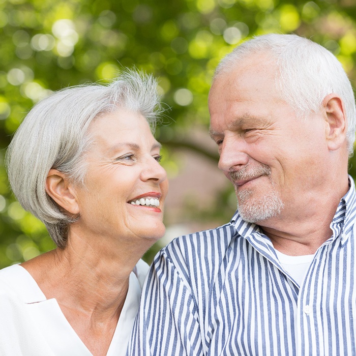 older couple smiling at each other 