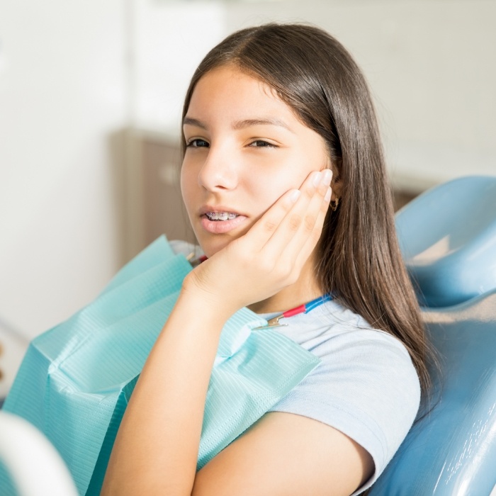 Young woman with mouth pain visiting emergency dentist in Arlington