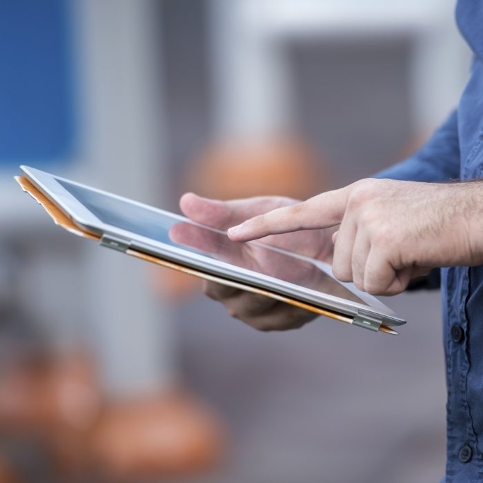 Person typing on a tablet