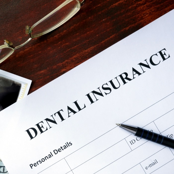 Dental insurance form on dark wood table