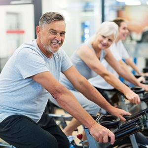 Group of friends smiling during cycling class
