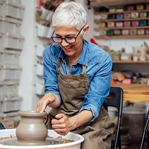 Senior woman smiling in pottery class
