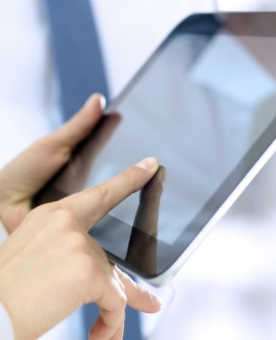 Person typing on tablet screen