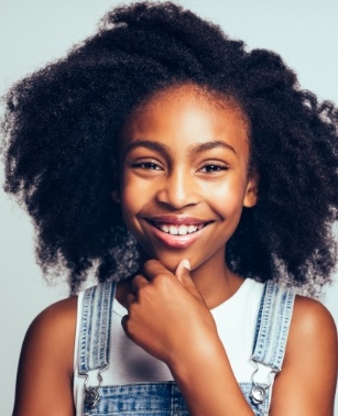 Smiling young girl wearing overalls