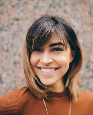 Smiling woman in orange sweater