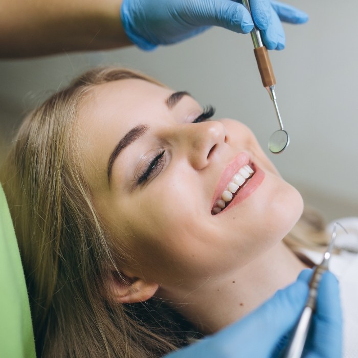 Woman smiling during preventive dentistry checkup