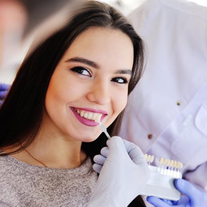 a patient smiling while undergoing the veneer process